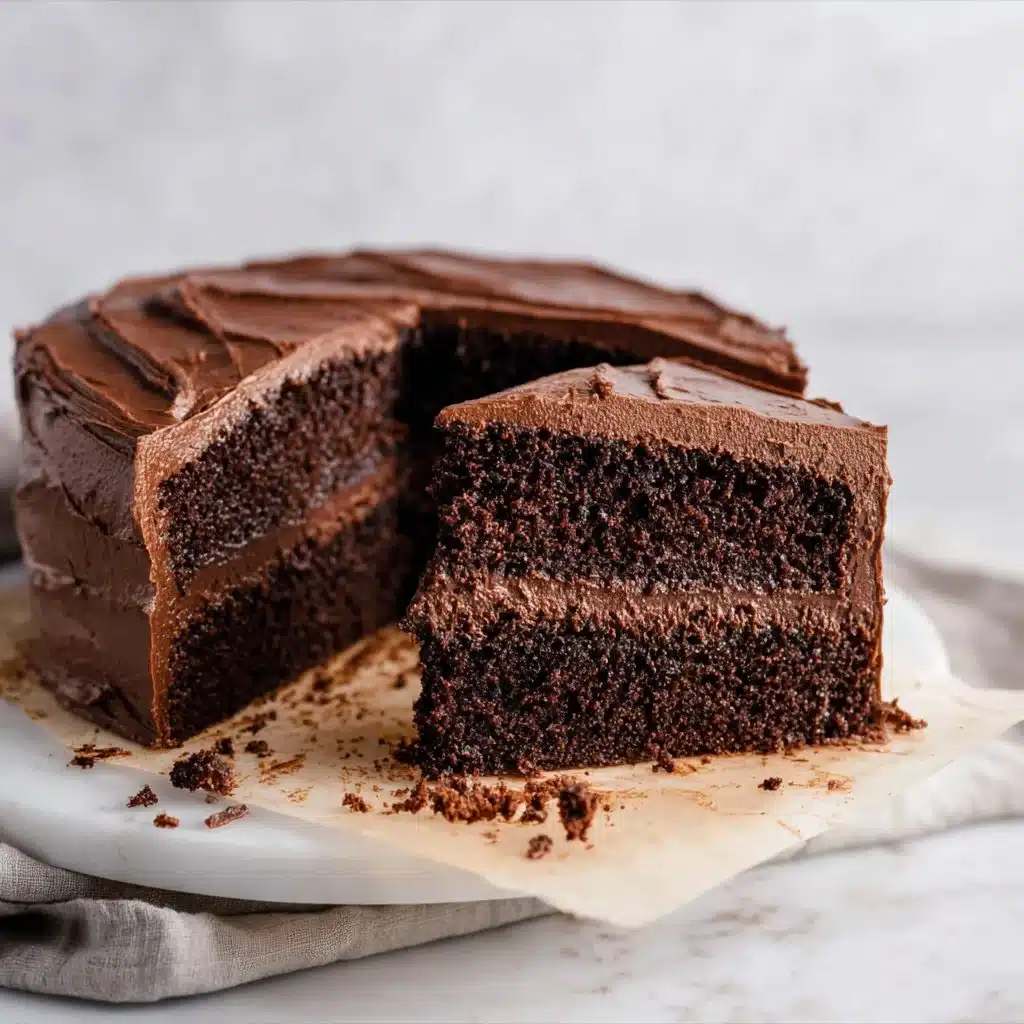 Delicious slice of ultimate chocolate cake topped with rich chocolate frosting