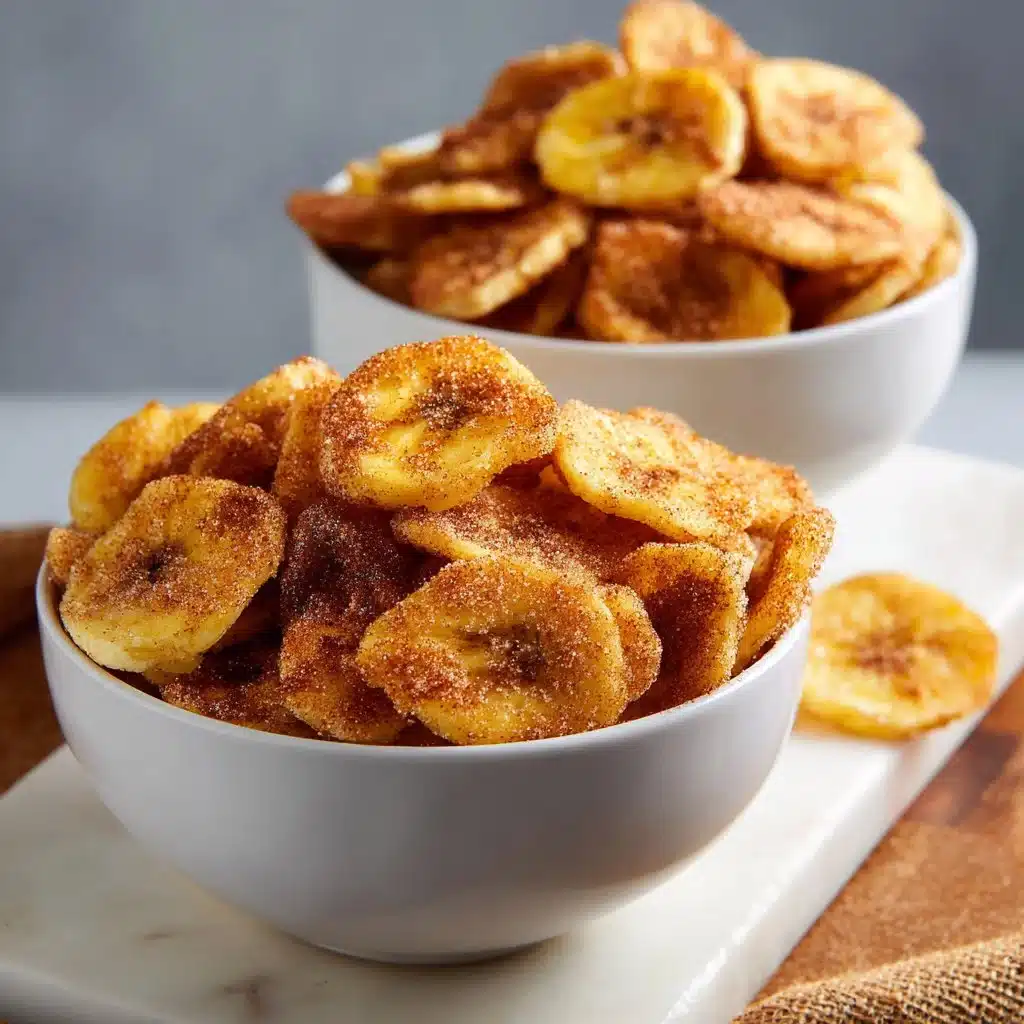 Crispy cinnamon sugar banana chips on a wooden table